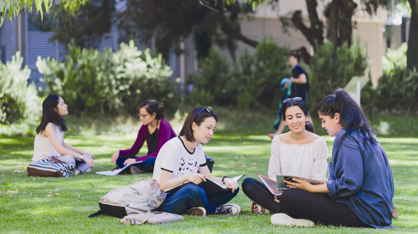 Students sitting on lawn at UWA
