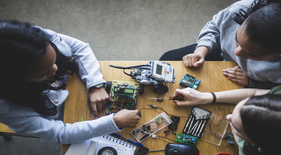 High angle view of female students preparing science project at desk