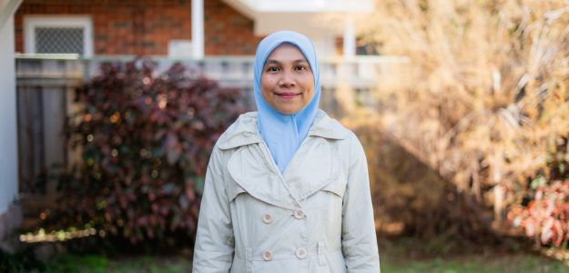 Nur Amalia standing outside on UWA campus with trees in the background