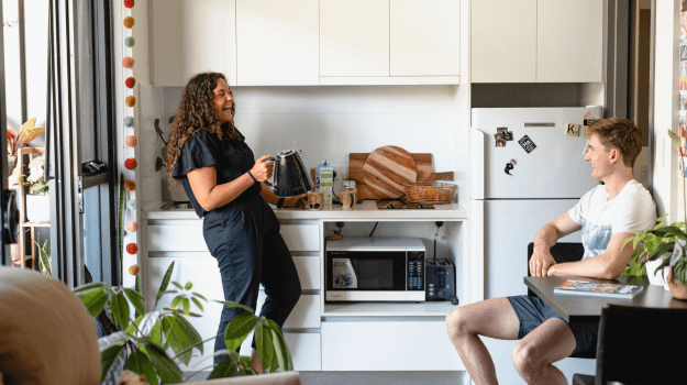 Two students in kitchen in student accommodation at UWA
