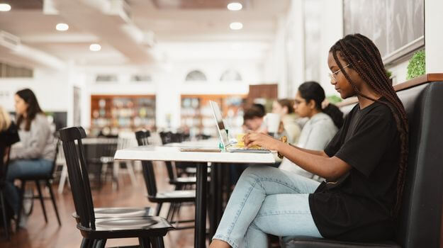 Student studying in cafe on campus at UWA