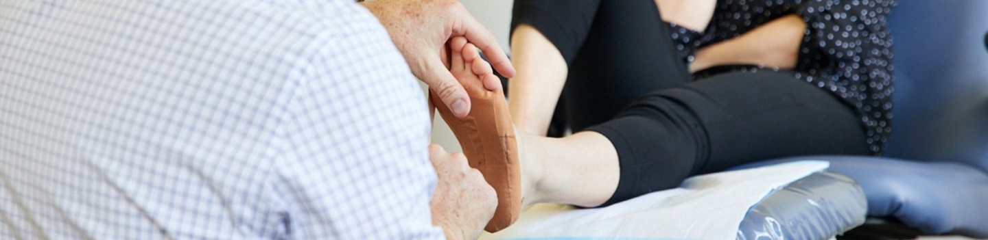 Podiatrist strapping a foot