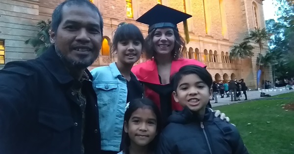 Family of five stand outside Winthrop Hall after graduation