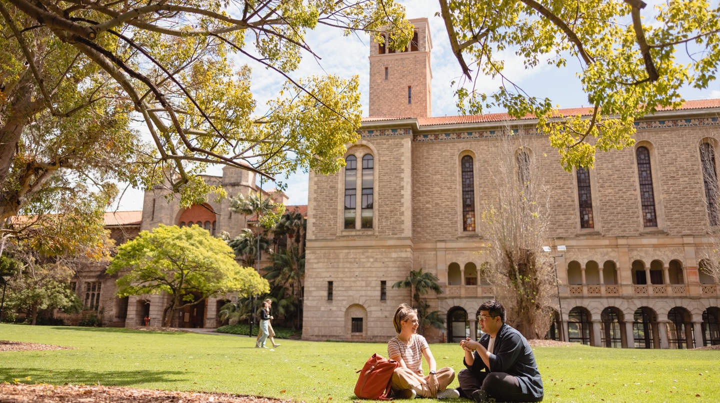 Two students sitting outside Winthrop Hall