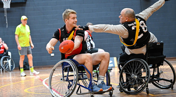 Two players competing in Wheelchair Footy in the West Australian All Abilities Football Association 