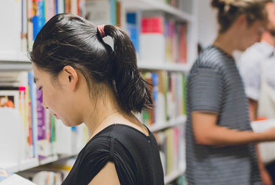 Student looking at books in a library