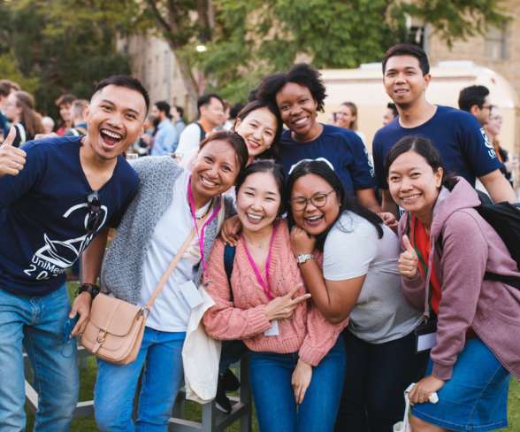 Group of students at UWA smiling and laughing at Orientation events