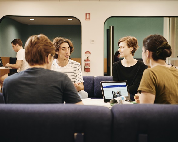 Students sitting in a group discussing ideas