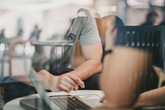 abstract image of student sitting at a table