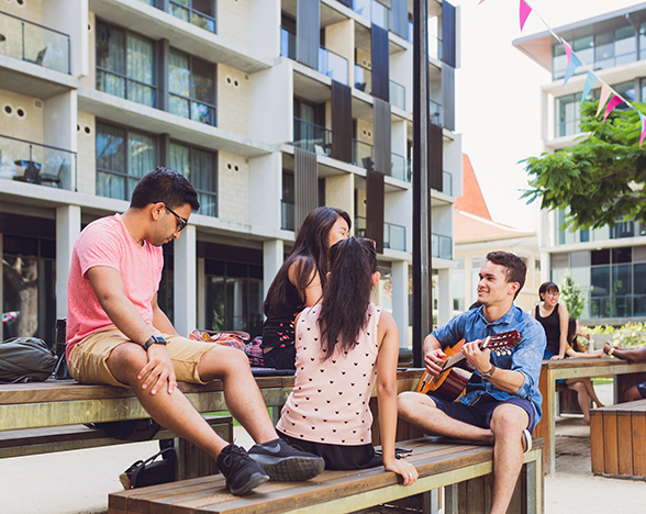 students sitting outside unihall