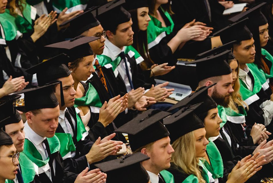 Crowd of graduands applauding