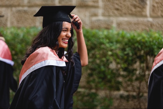 Student smiling in graduation regalia