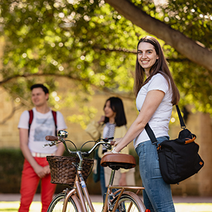 Female student with bike posing at UWA College