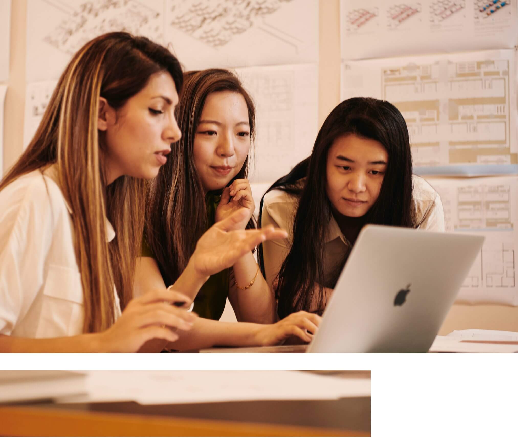 Three women looking at laptop