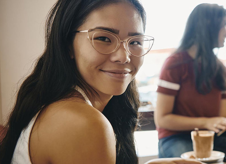student with glasses smiling