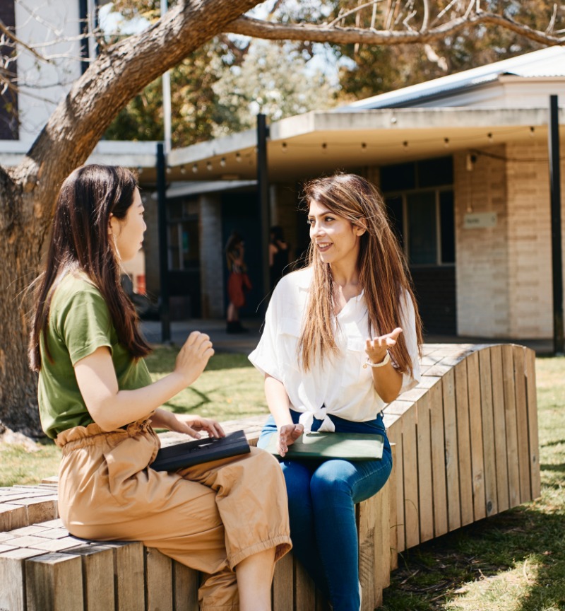 Two students sitting and talking