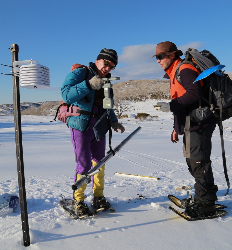 Two geographers working in the snow fields. 