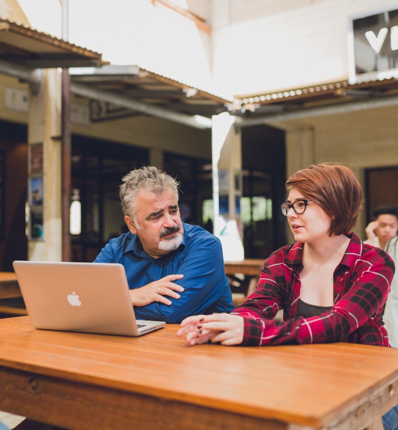 Two students having a chat at a table 