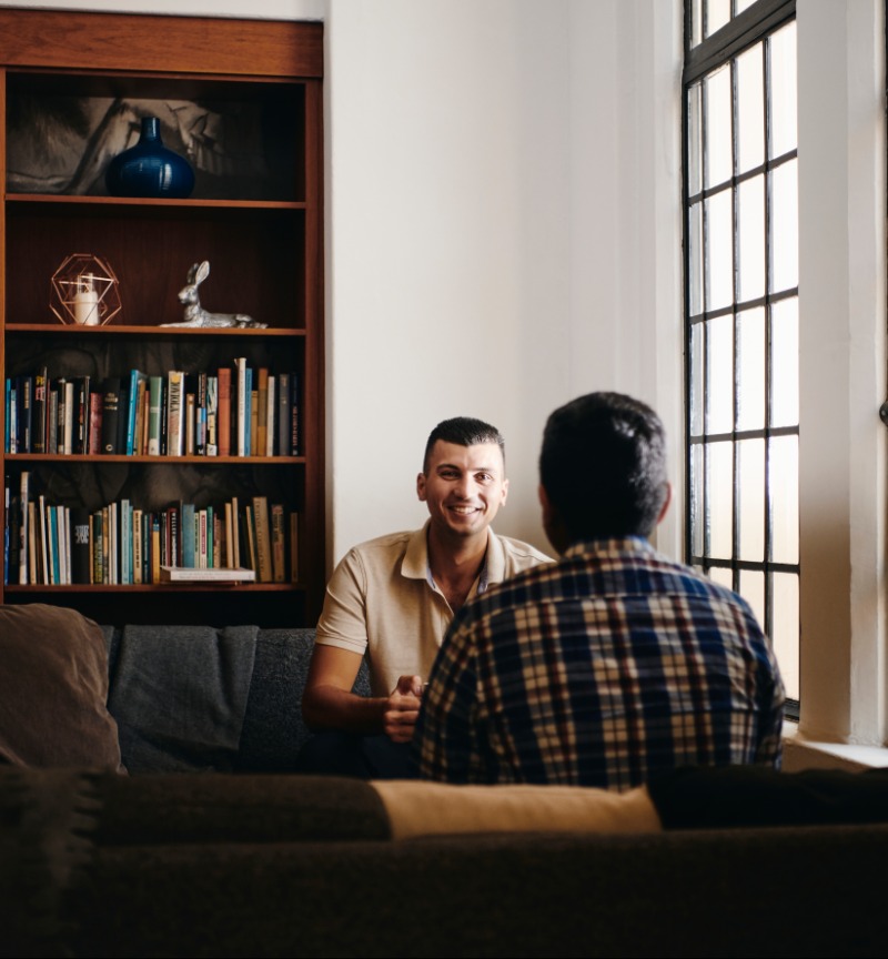 Two students having a conversation in a library