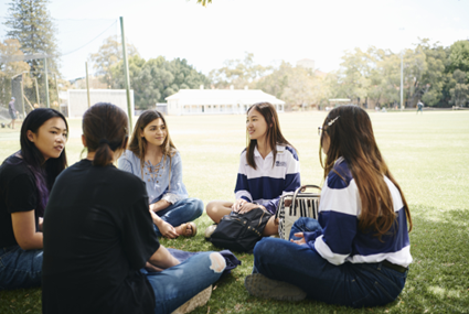 Student sitting on campus talking