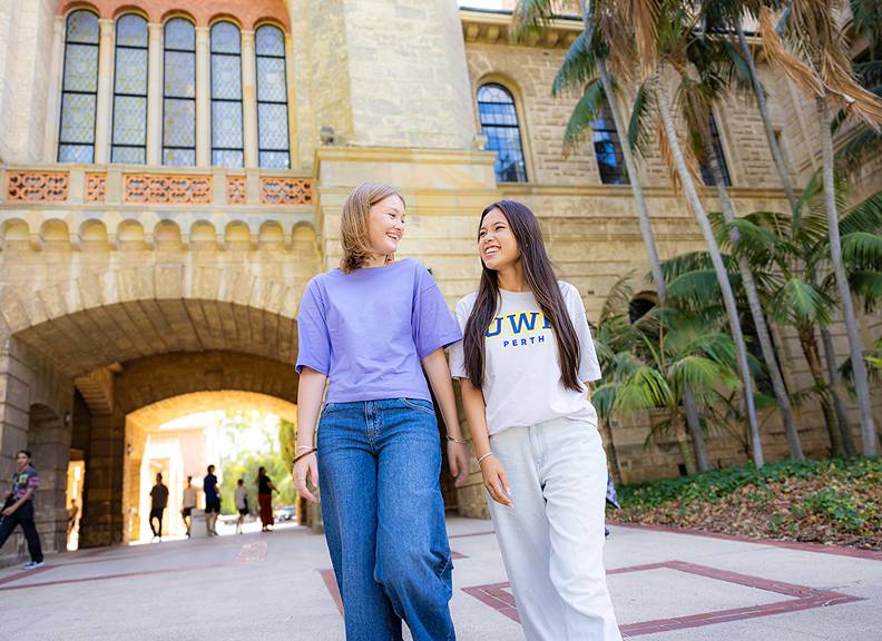 Image of 2 student walking on campus