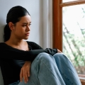 woman sitting on floor in front of window