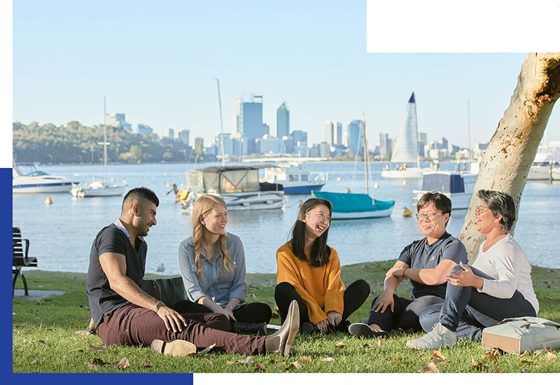 Group of students sitting on the grass of Matilda Bay talking