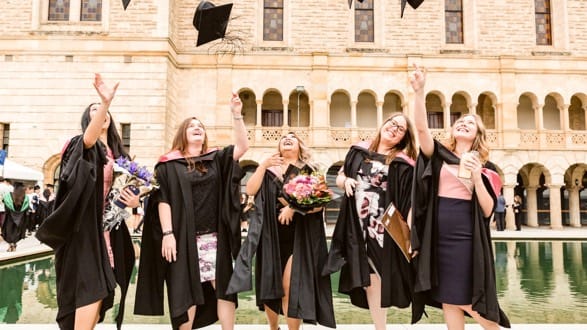 graduates celebrating outside withrop hall