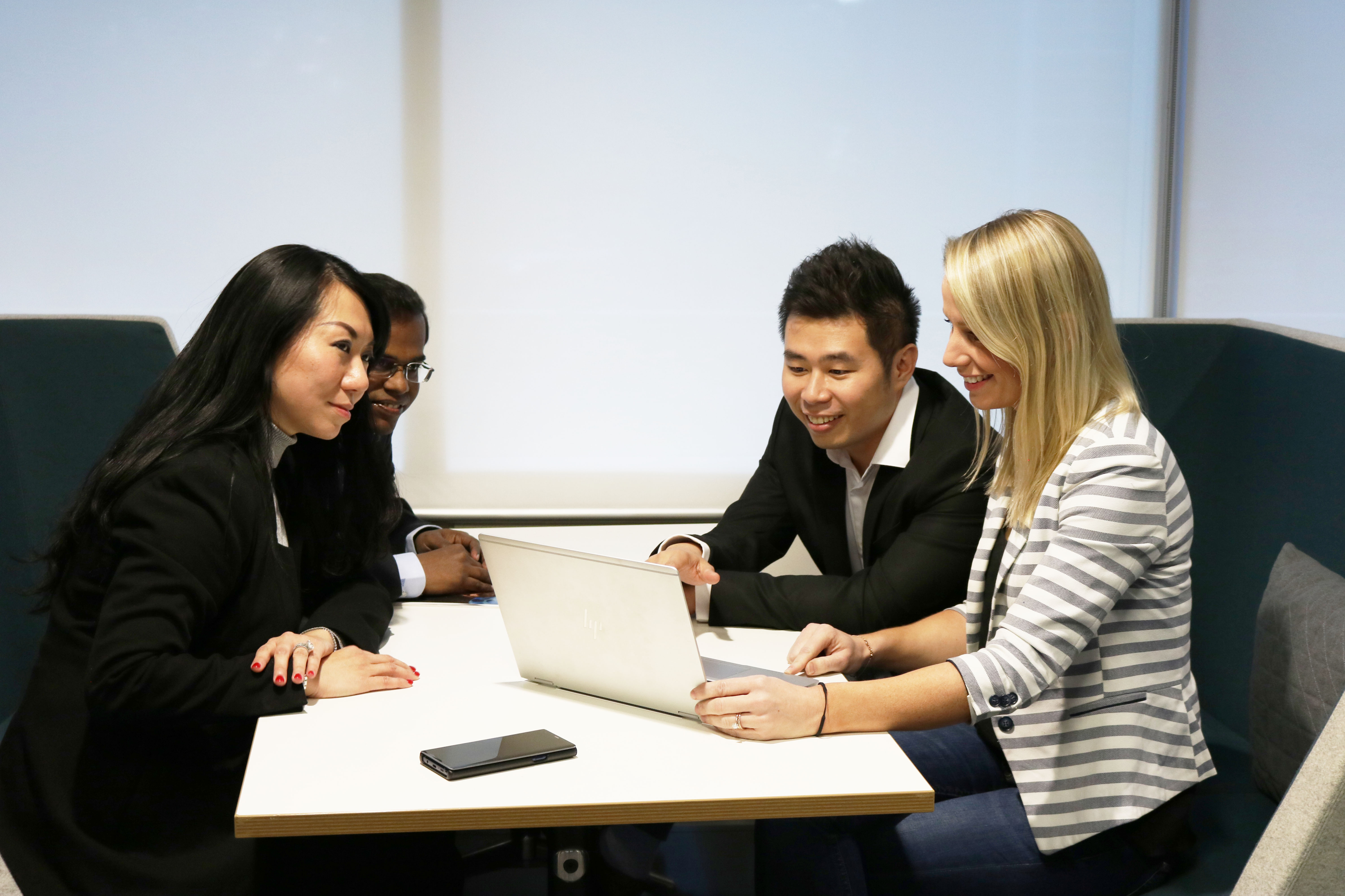 Students looking at laptop at desk