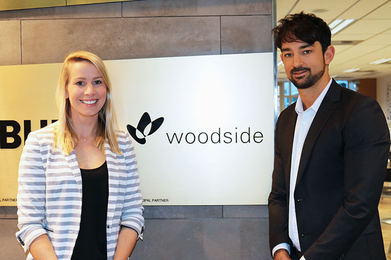 Students standing beside Woodside sign