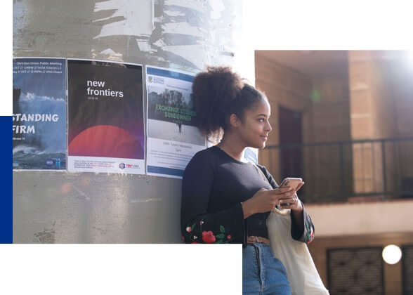 student leaning against pillar