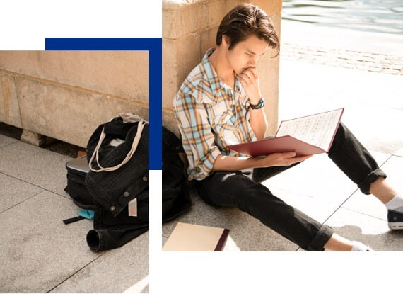 Student reading outside on campus