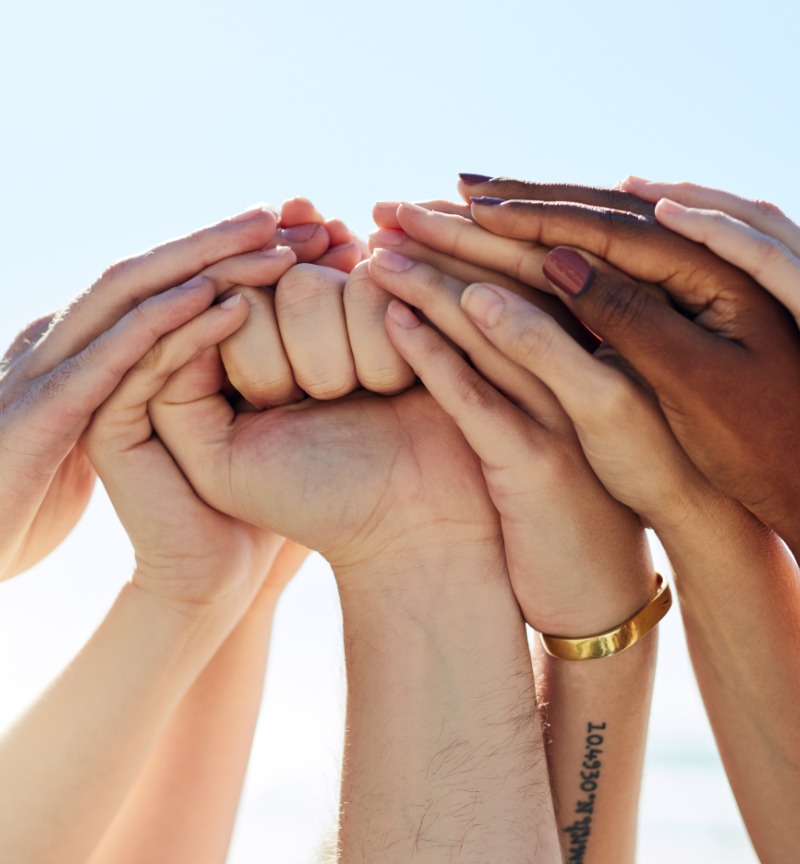 Group of hands raised up to the sky