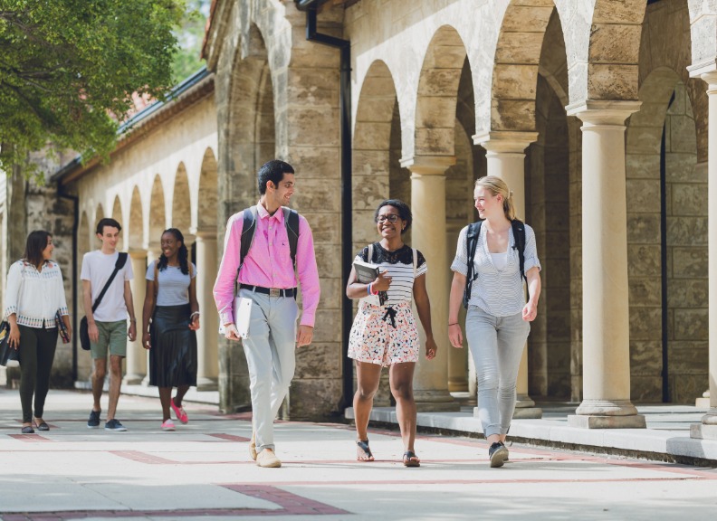 three students walking through campus