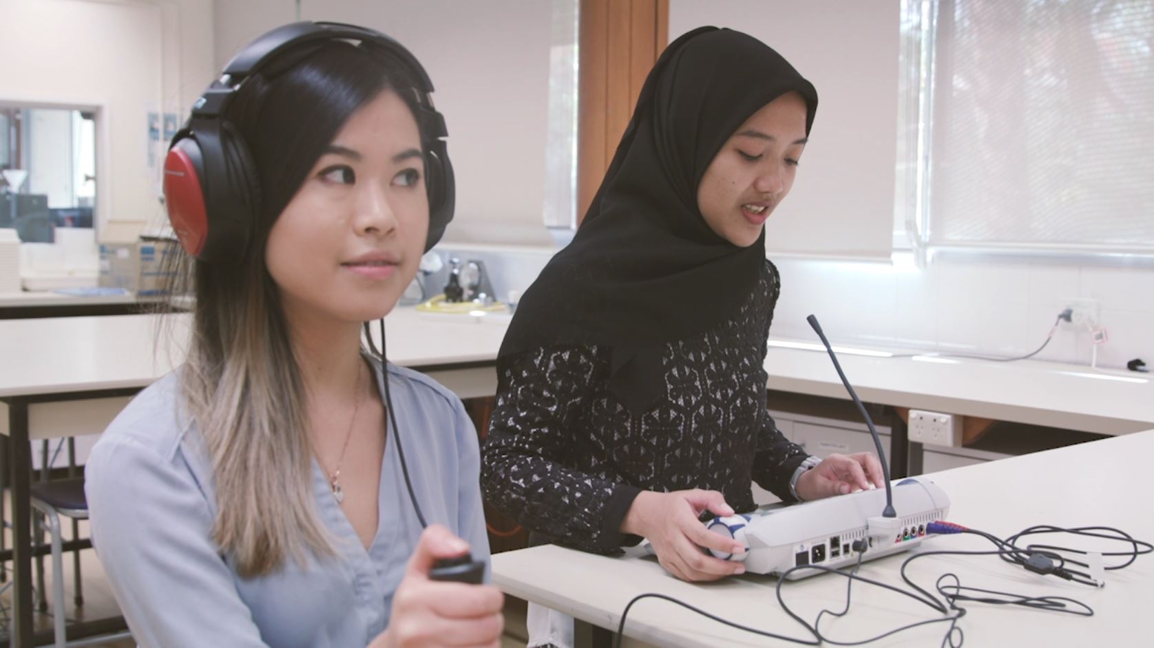 Audiology students testing hearing 